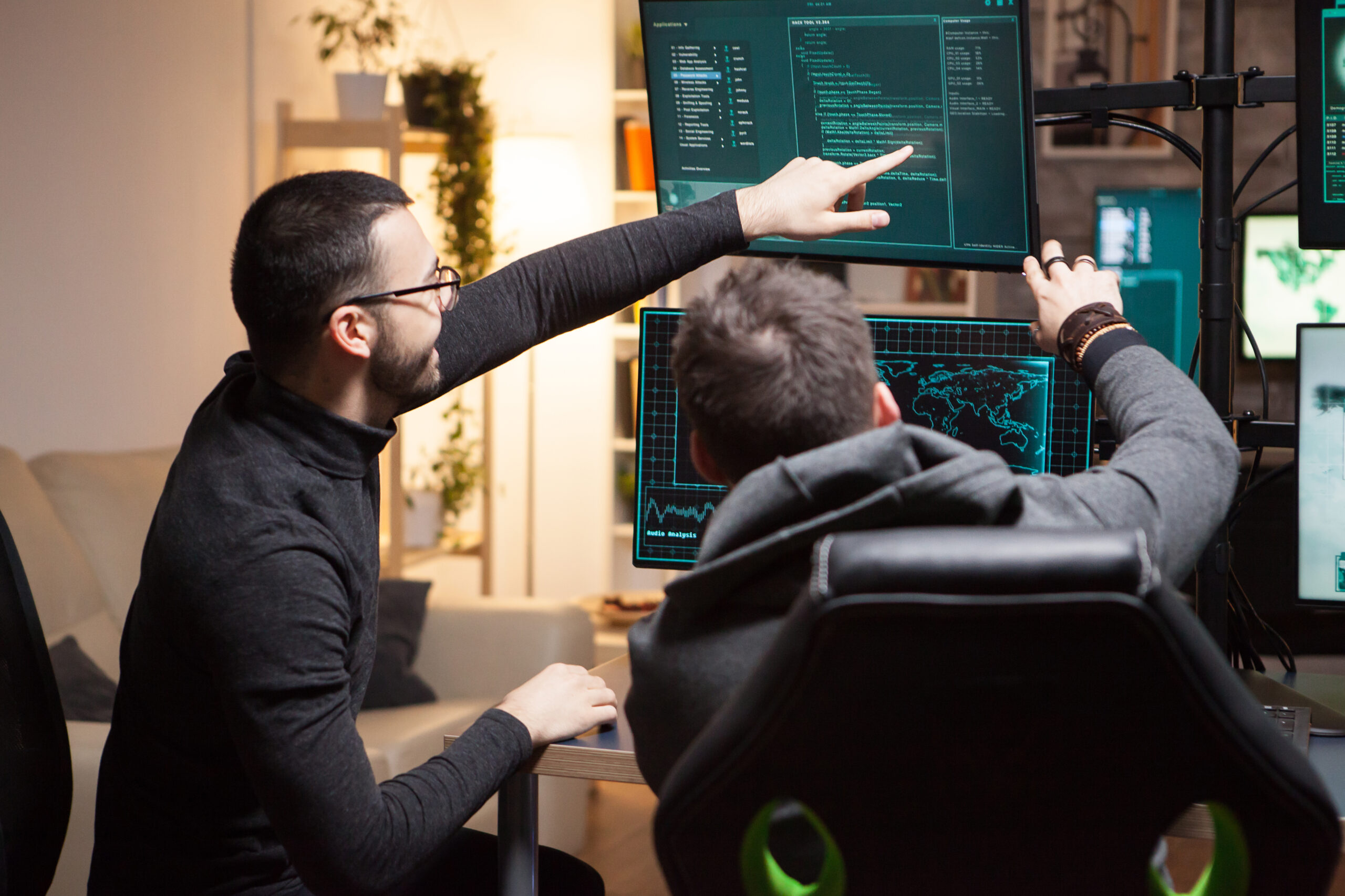Back view of hackers pointing on computer screens 2026 03 19 01 59 37 utc scaled